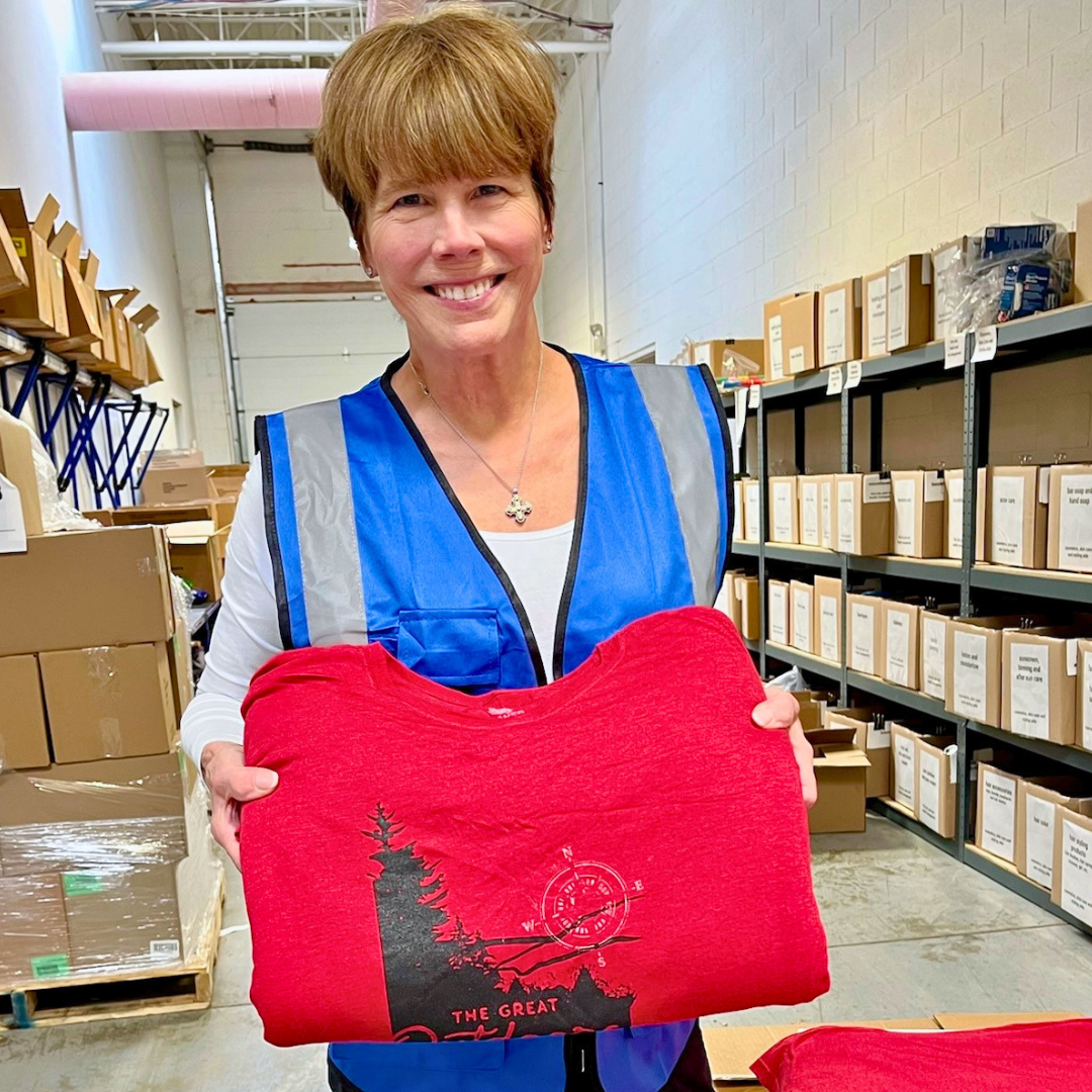 A GiveNKind volunteer sorting sweatshirts donated to GiveNKind