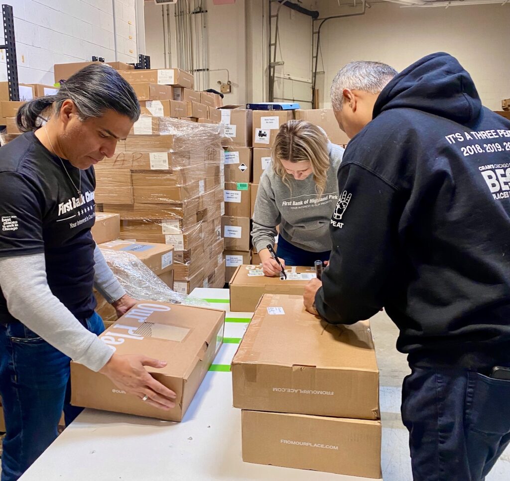 Volunteers from First Bank of Chicago inspecting cooking pans to be distributed to local families