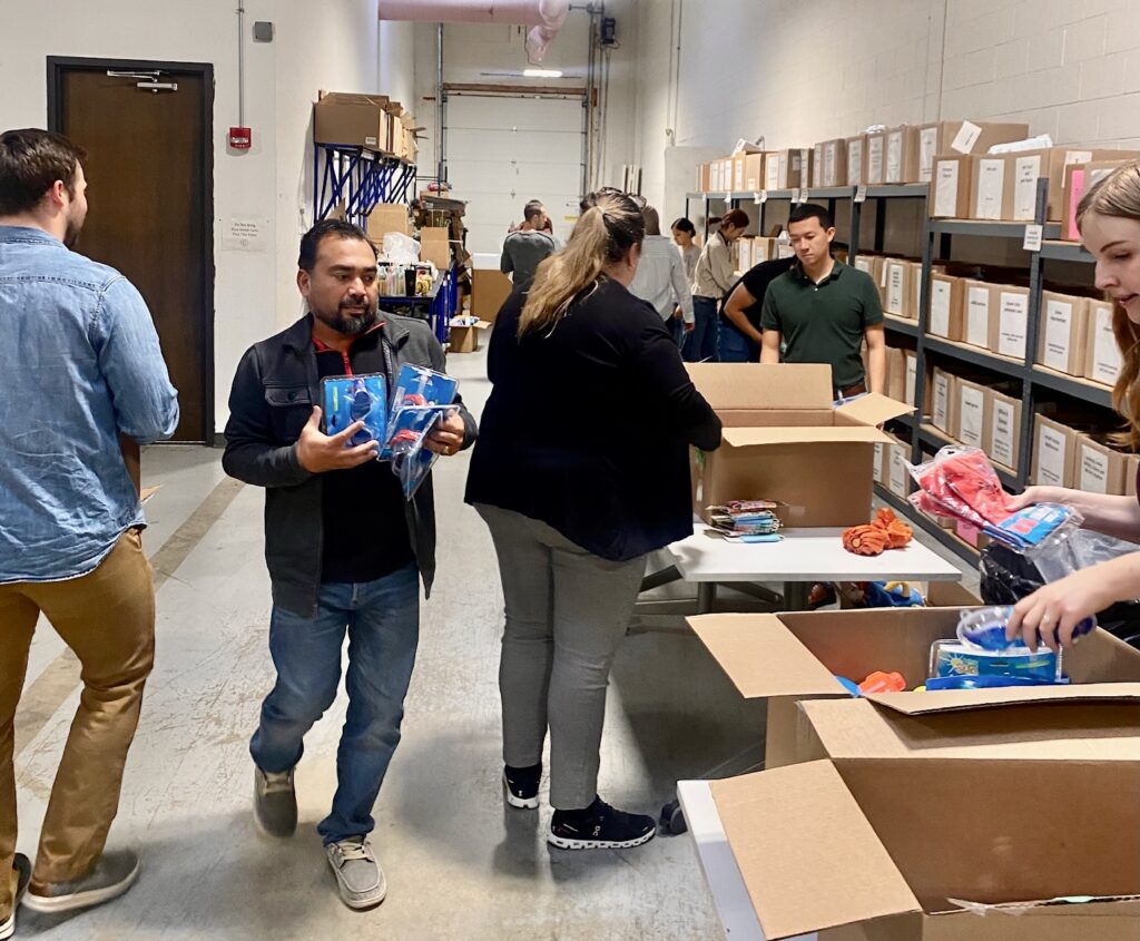 Team of Corporate Volunteers sorting a Walgreens donation